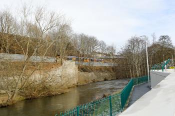 66761 and 66741 wait to push the track laying train towards Tweedbank with this view looking towards Galashiels with Gala Water in the foreground on 4th Feb 2015